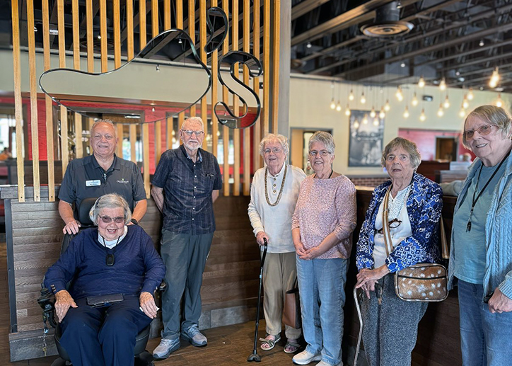 Group photo of seniors and team members at a local restaurant for a meal out.